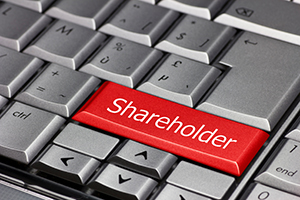 A computer keyboard with a highlighted shareholder key