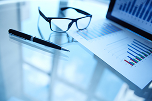 Shows a report, glasses and pen